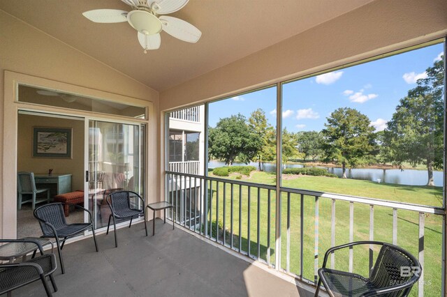 sunroom featuring a water view, ceiling fan, and lofted ceiling