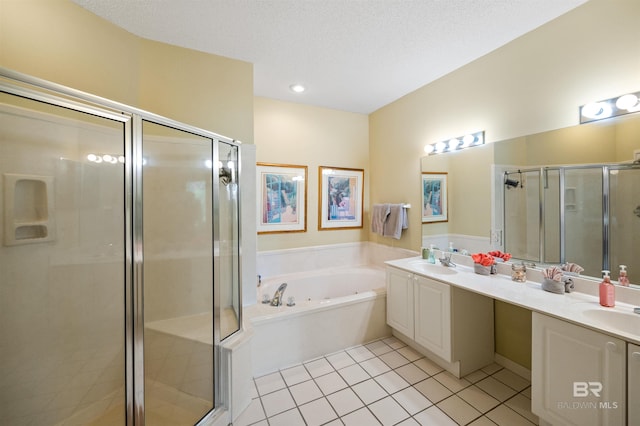 bathroom with independent shower and bath, vanity, a textured ceiling, and tile patterned floors