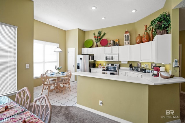 kitchen featuring white cabinetry, appliances with stainless steel finishes, light carpet, and decorative light fixtures