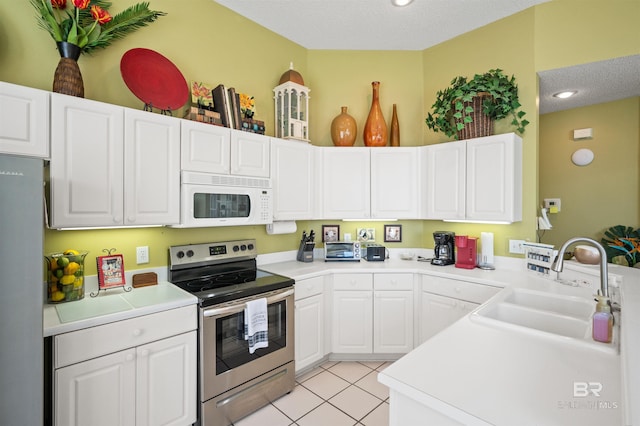 kitchen featuring white cabinetry, white appliances, sink, and a textured ceiling