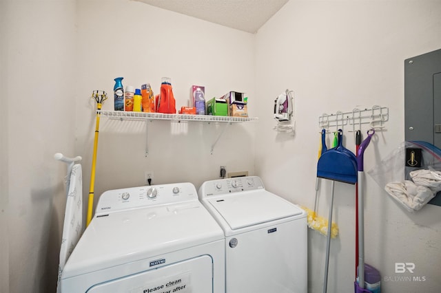 laundry room with washer and dryer and a textured ceiling