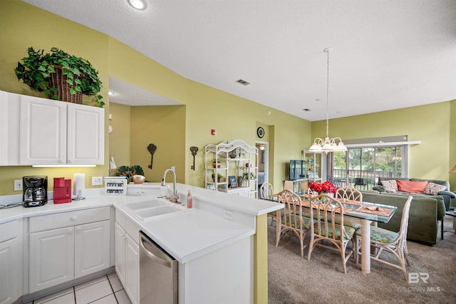 kitchen featuring sink, white cabinets, dishwasher, kitchen peninsula, and light colored carpet