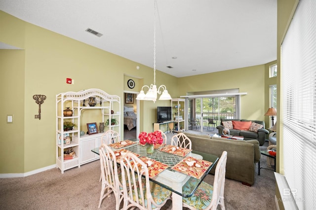 dining room featuring carpet flooring and a notable chandelier