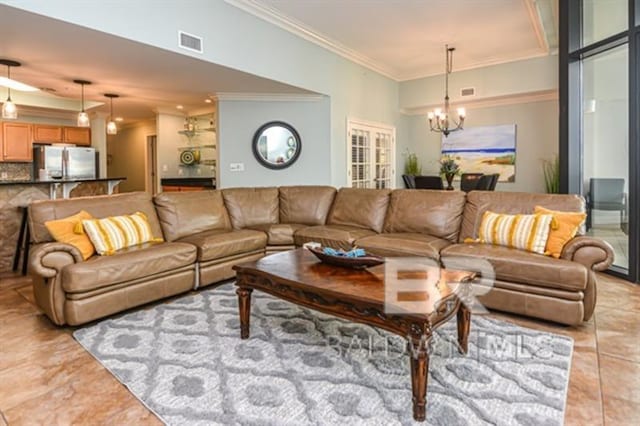 living room with ornamental molding, light tile patterned floors, and a chandelier