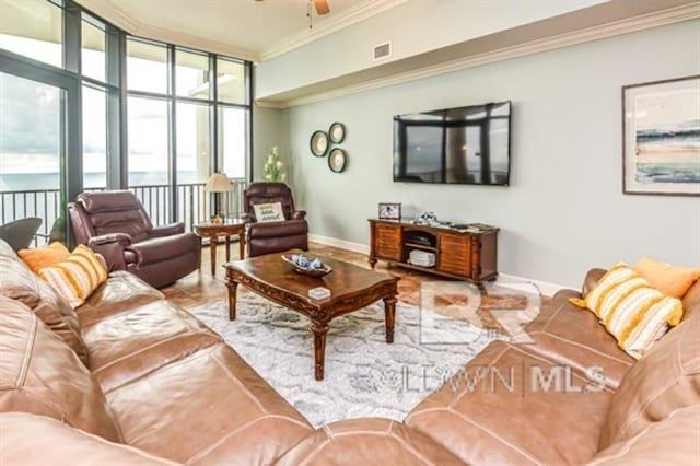 living room featuring crown molding, ceiling fan, and expansive windows