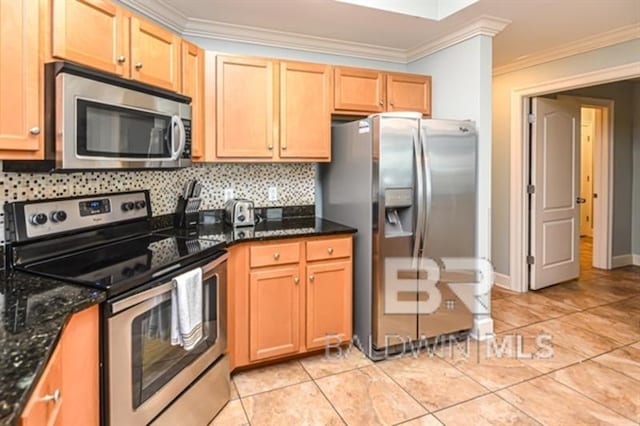 kitchen with crown molding, light tile patterned floors, dark stone counters, stainless steel appliances, and backsplash