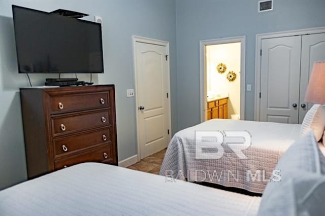 bedroom with connected bathroom and a closet