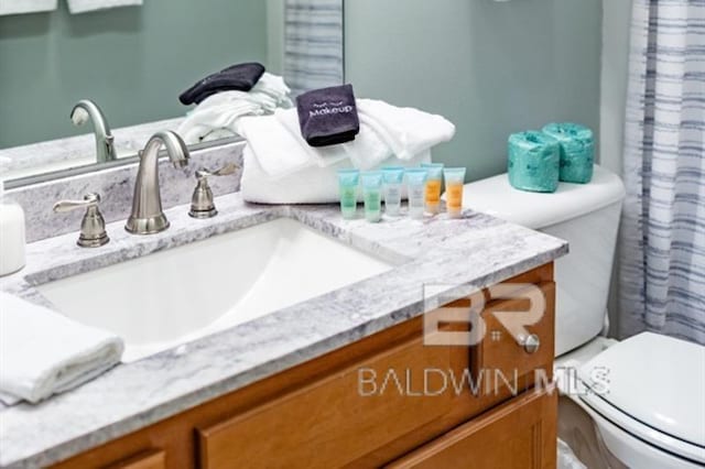 bathroom featuring vanity and toilet