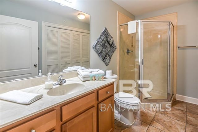 bathroom with walk in shower, vanity, and toilet