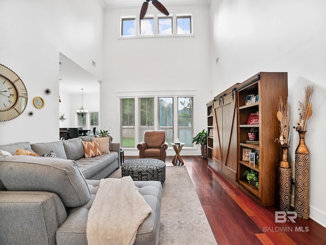 living room featuring dark wood-type flooring and a chandelier