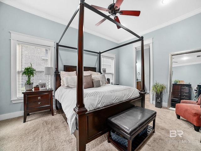 bedroom with ensuite bathroom, crown molding, light carpet, and ceiling fan