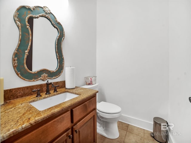 bathroom featuring tile patterned flooring, vanity, and toilet