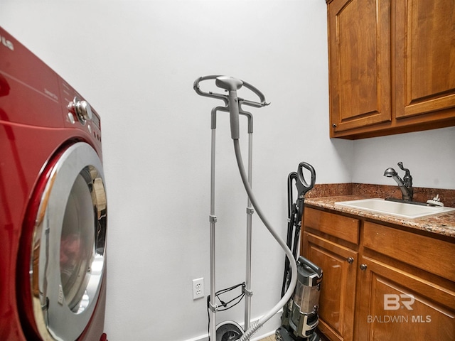 laundry room featuring cabinets, washer / dryer, and sink