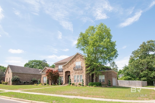 front of property with a garage and a front lawn