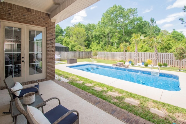 view of swimming pool featuring a patio area and french doors