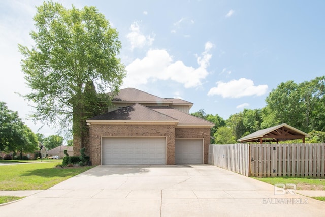 exterior space featuring a garage and a front lawn