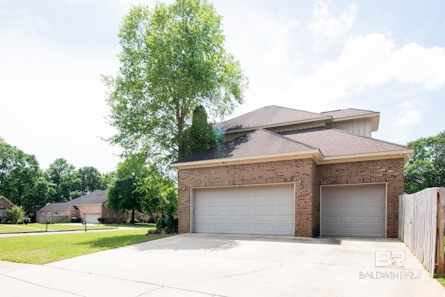 view of front of property featuring a garage and a front yard