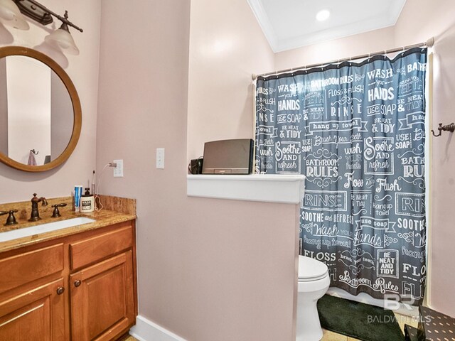 bathroom featuring vanity, toilet, and ornamental molding