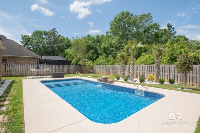 view of pool featuring a patio, pool water feature, and a yard