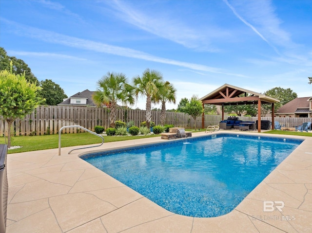 view of swimming pool with pool water feature, a patio area, and a gazebo