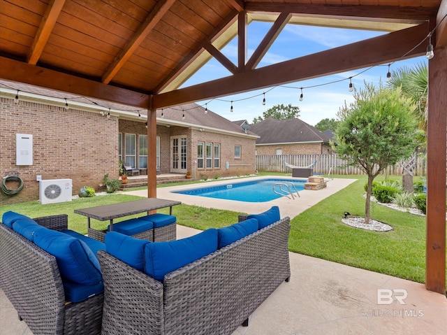 view of pool with cooling unit, outdoor lounge area, a patio, and a lawn