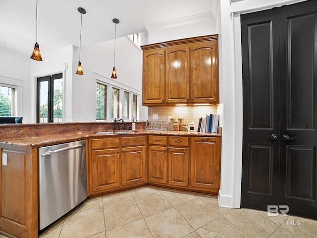 kitchen with hanging light fixtures, light tile patterned flooring, dishwasher, and tasteful backsplash