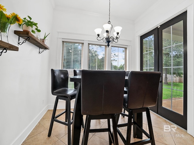 tiled dining room with crown molding, an inviting chandelier, and french doors