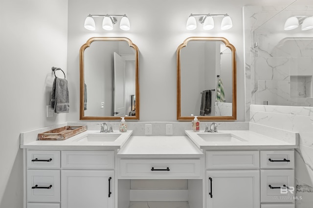 bathroom with vanity and tiled shower