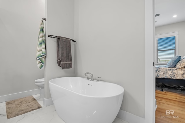 bathroom featuring toilet and a bathing tub