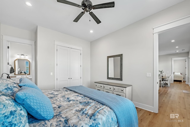 bedroom with light hardwood / wood-style floors, a closet, and ceiling fan