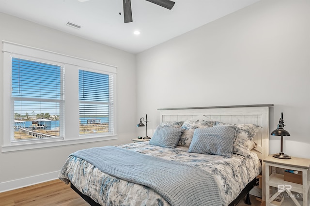 bedroom with hardwood / wood-style floors and ceiling fan