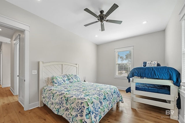 bedroom with ceiling fan and hardwood / wood-style flooring