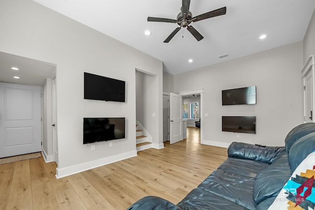 living room with ceiling fan and hardwood / wood-style floors