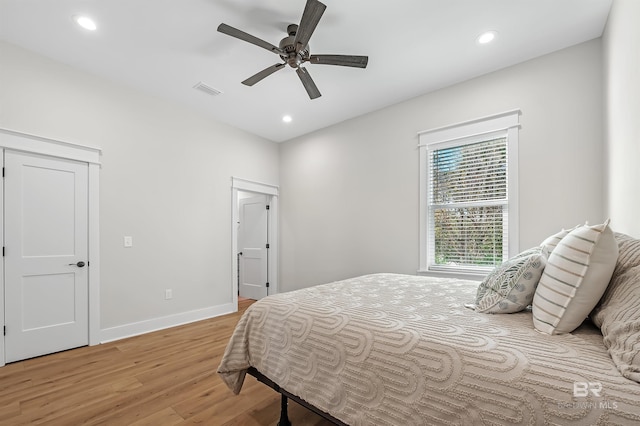 bedroom with light hardwood / wood-style flooring and ceiling fan