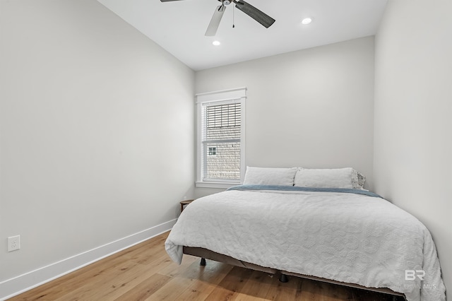 bedroom with light hardwood / wood-style floors and ceiling fan