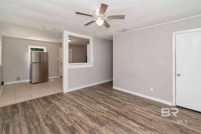 6451 S Barker Dr, Mobile, AL 36608 - unfurnished room with a ceiling fan, wood finished floors, baseboards, and a textured ceiling
