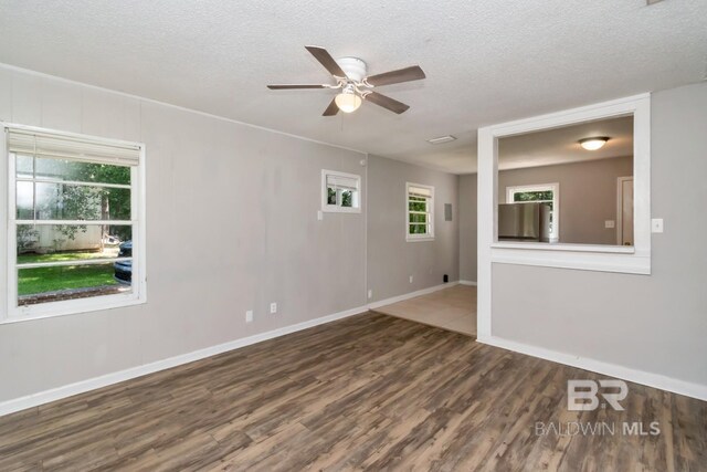 6451 S Barker Dr, Mobile, AL 36608 - spare room featuring a ceiling fan, wood finished floors, a textured ceiling, and baseboards