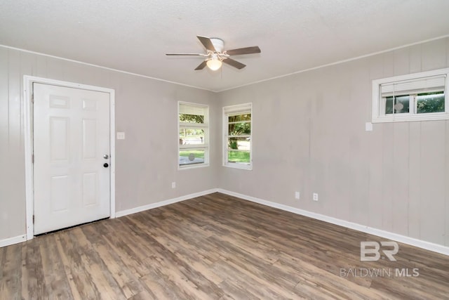 6451 S Barker Dr, Mobile, AL 36608 - empty room featuring plenty of natural light, wood finished floors, ceiling fan, baseboards, and a textured ceiling