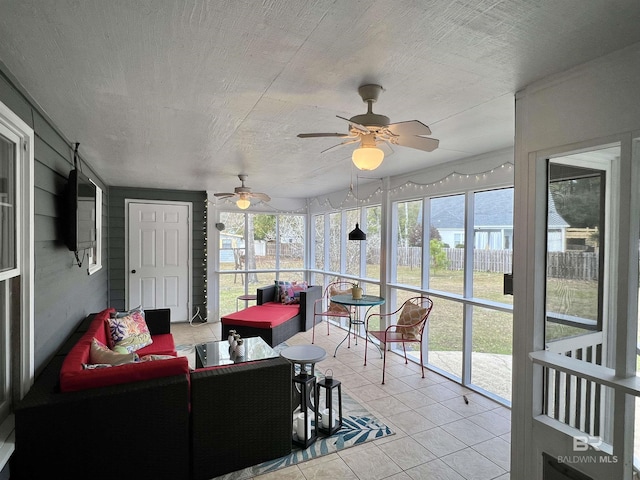 sunroom featuring ceiling fan