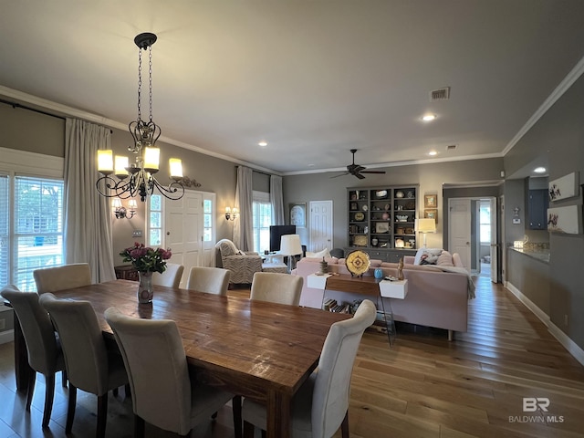 dining space featuring hardwood / wood-style floors, plenty of natural light, and ornamental molding