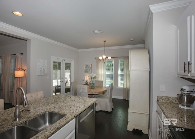kitchen with stainless steel dishwasher, a sink, crown molding, and french doors