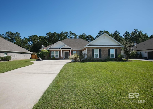 view of front of home with fence, concrete driveway, brick siding, and a front yard