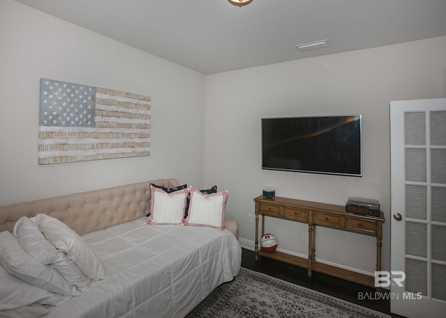 bedroom with baseboards and visible vents