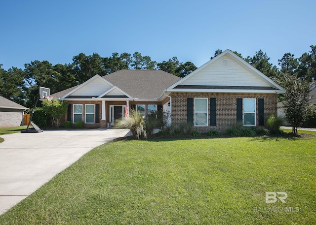 view of front of property featuring a front yard and brick siding