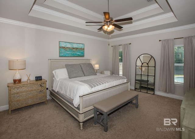 bedroom featuring crown molding, baseboards, carpet floors, and a raised ceiling