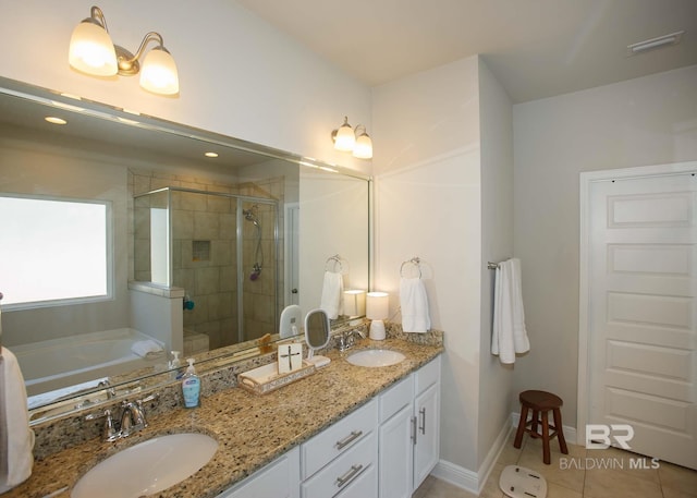 full bath featuring a sink, a shower stall, double vanity, and visible vents