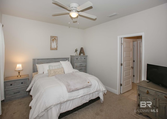 carpeted bedroom with baseboards, a ceiling fan, and visible vents