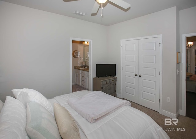 bedroom with a ceiling fan, visible vents, baseboards, a closet, and carpet