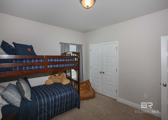 bedroom featuring baseboards and carpet