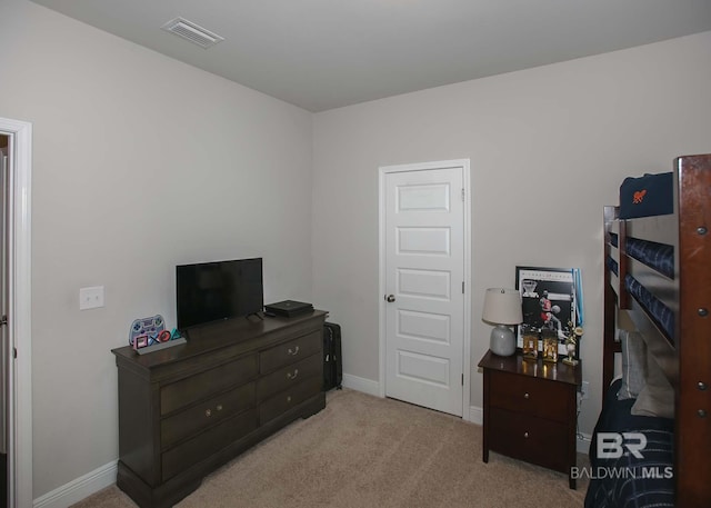 carpeted bedroom featuring baseboards and visible vents